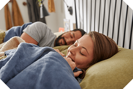 Woman and man laying on pillow