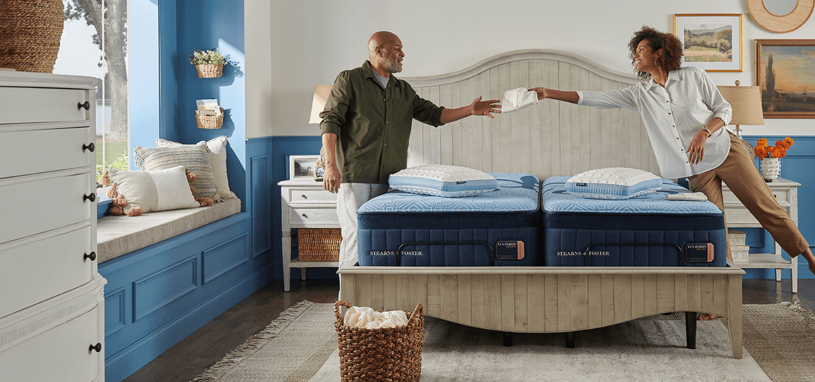 A couple putting their Stearns & Foster sheets on their mattress