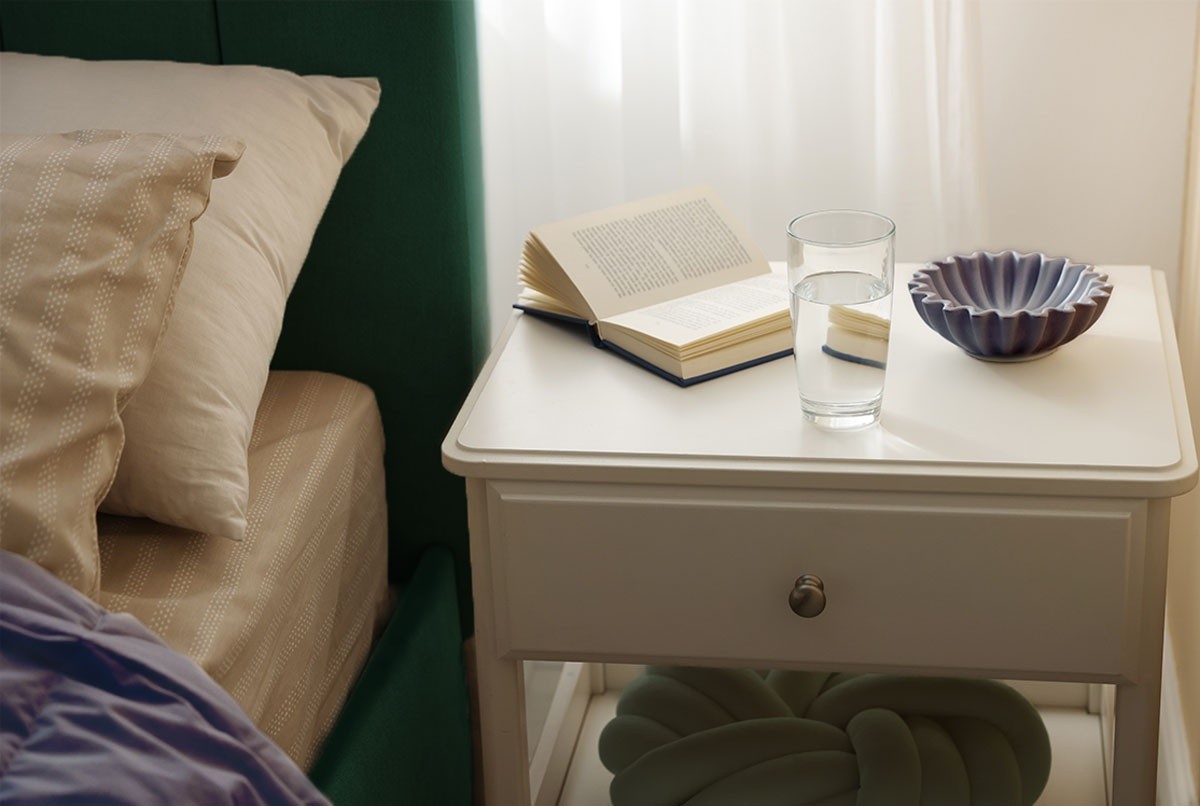 A glass of water on a nightstand